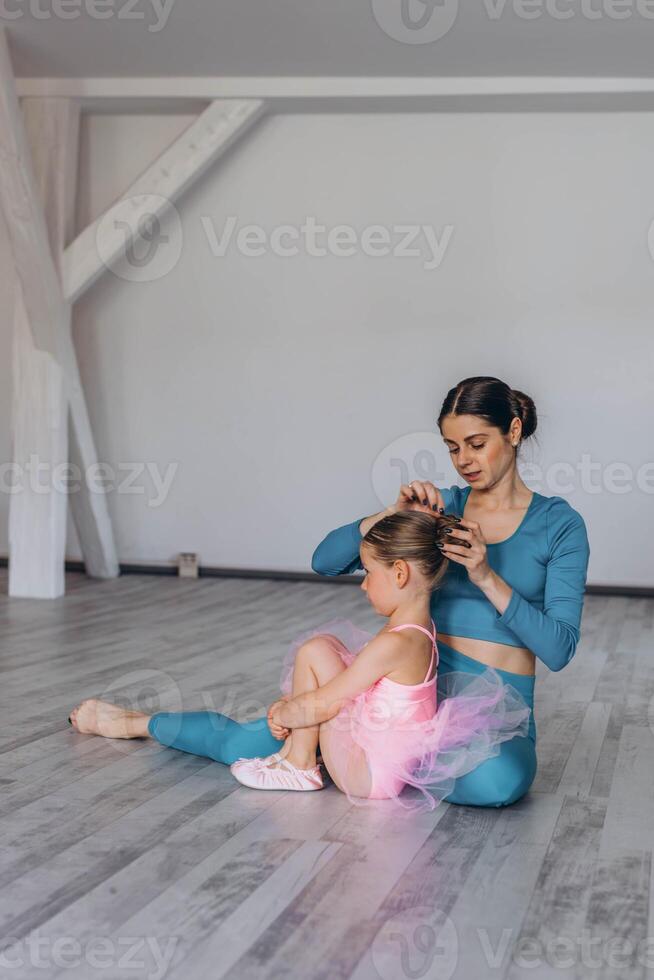 Baby ballet studio. Little ballerina with a coach in dance class. Ballet trainer for children photo