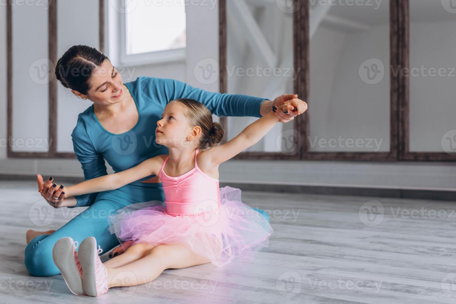 Baby ballet studio. Little ballerina with a coach in dance class. Ballet trainer for children photo