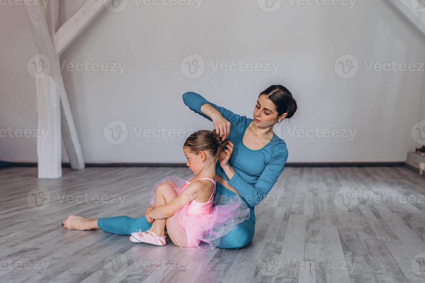 Baby ballet studio. Little ballerina with a coach in dance class. Ballet trainer for children photo