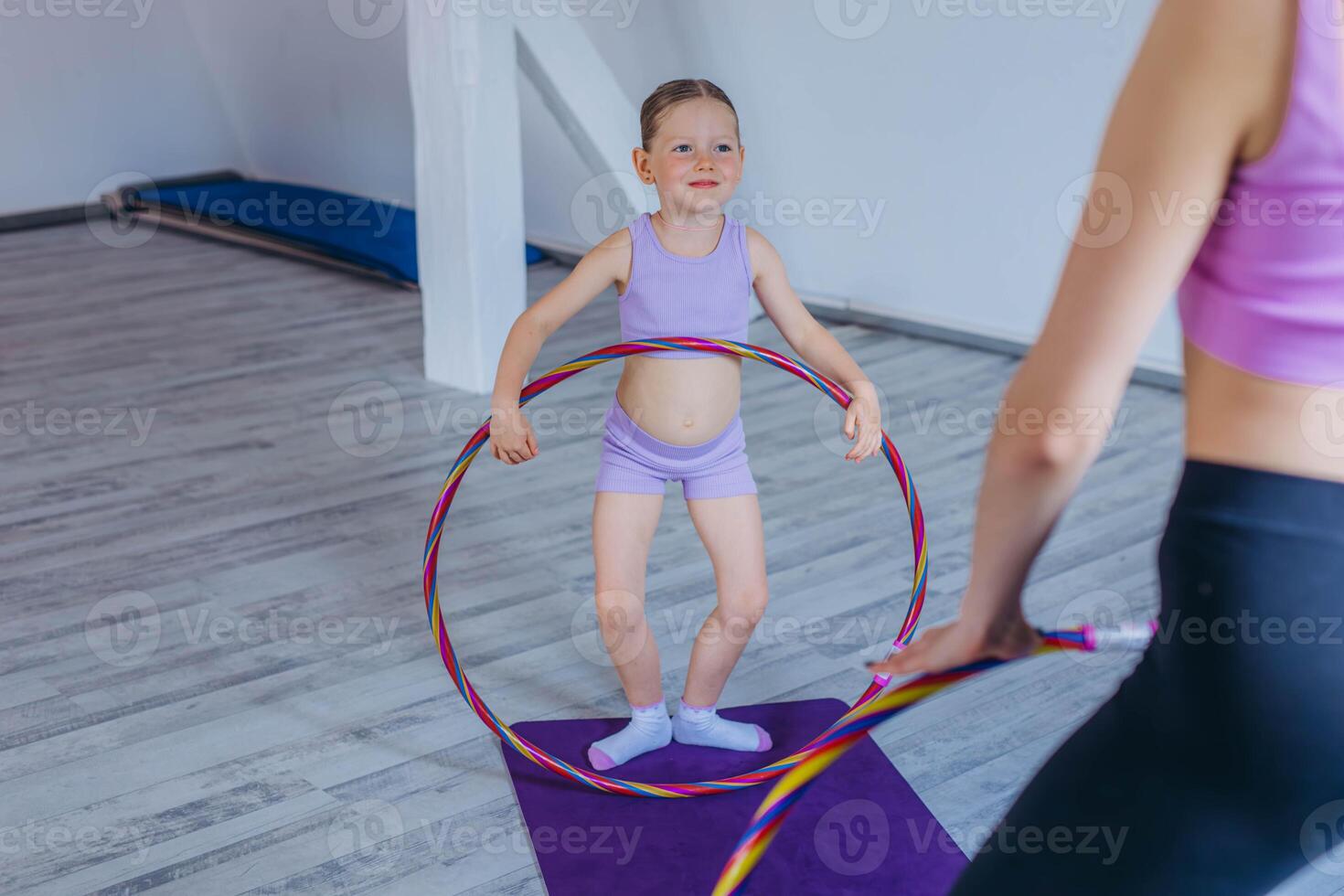 Gymnast child performs an exercise with hoop.Children's professional sports. photo