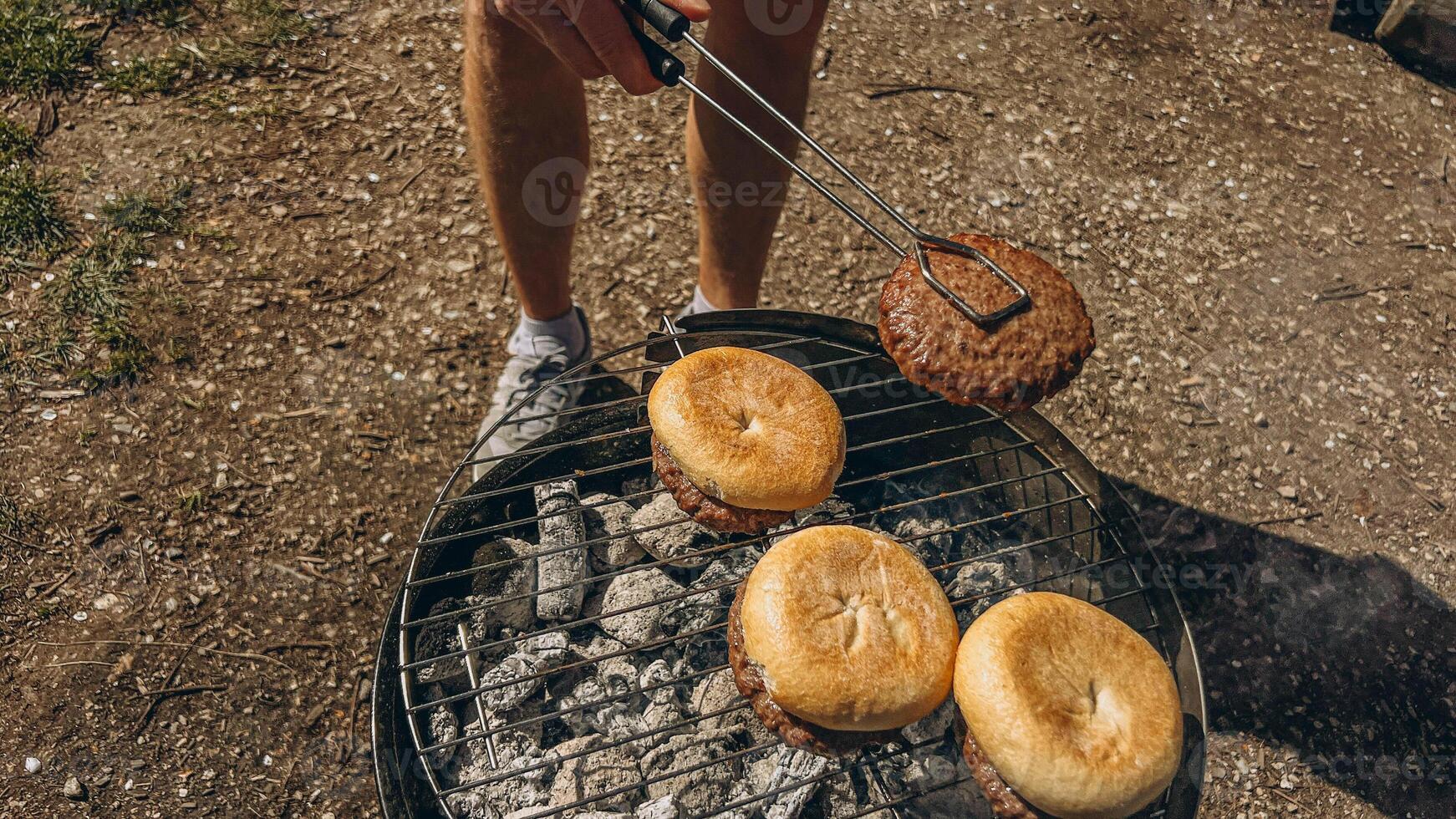 man grilling bread for burgers. photo