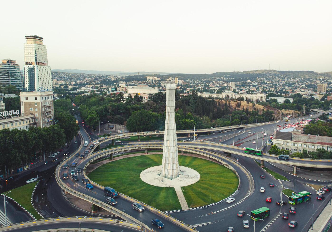 Tbilisi, Georgia - 15th july, 2022 - static view automobiles in traffic on roundabout in Tbilisi center. Square of heroes monument photo