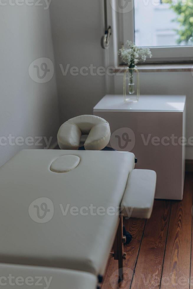 Massage table close-up. Massage table with headrest and hand rests. photo