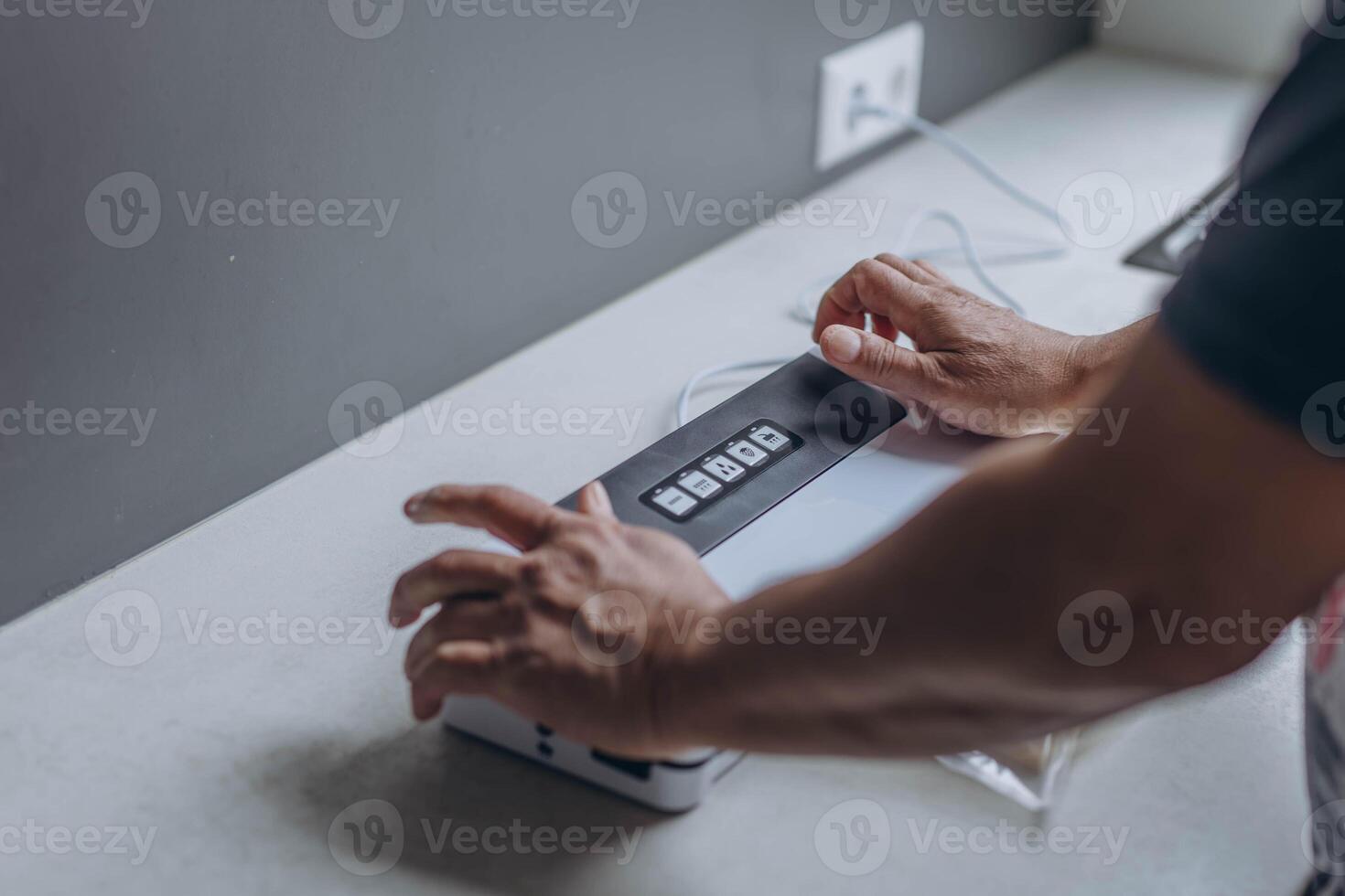 man vacuum-packing cheese with a vacuum cleaner photo