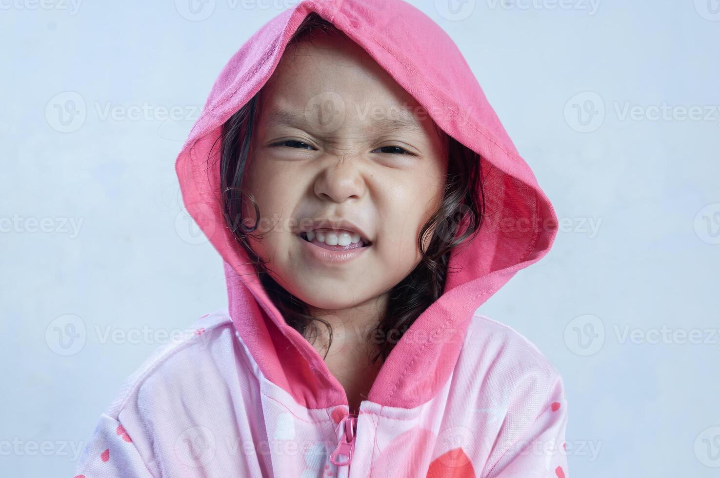 an Indonesian little girl wearing sweater with hoodie photo