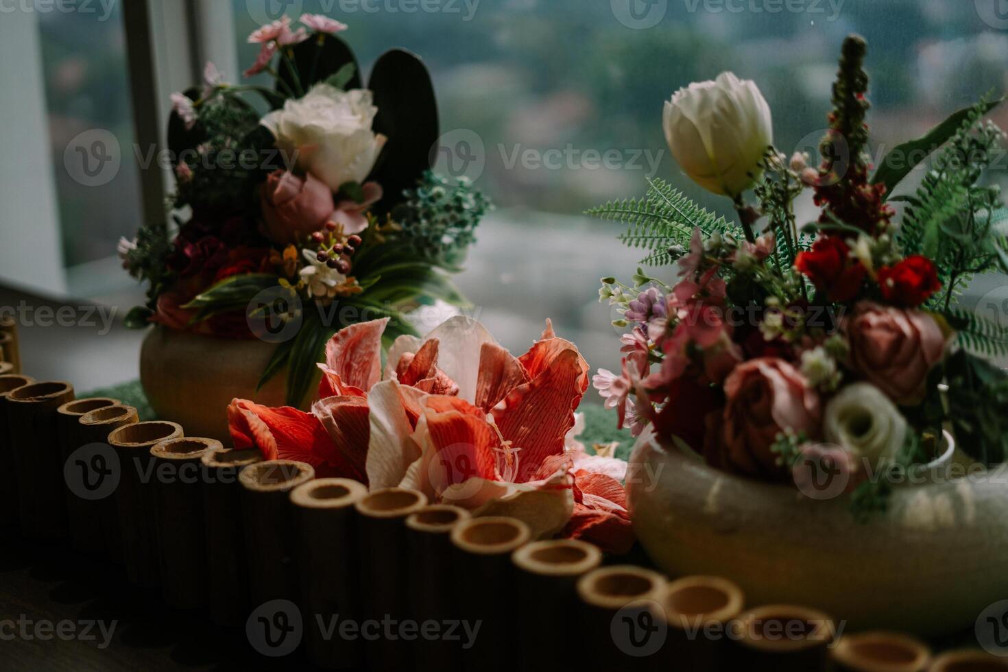 Exquisite floral centerpiece adorning a hotel table, adding a touch of elegance and freshness to the ambiance. photo
