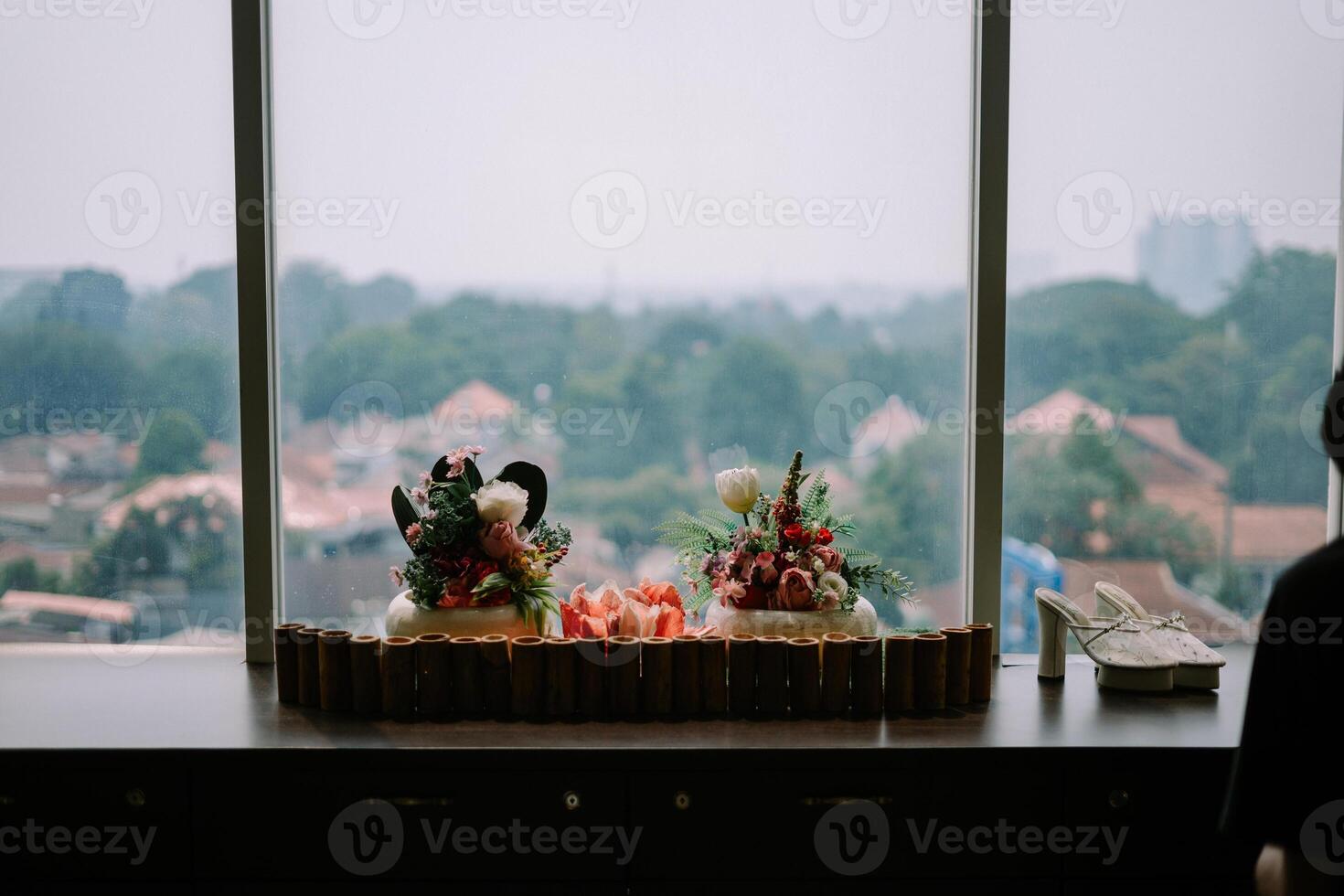 Exquisite floral centerpiece adorning a hotel table, adding a touch of elegance and freshness to the ambiance. photo