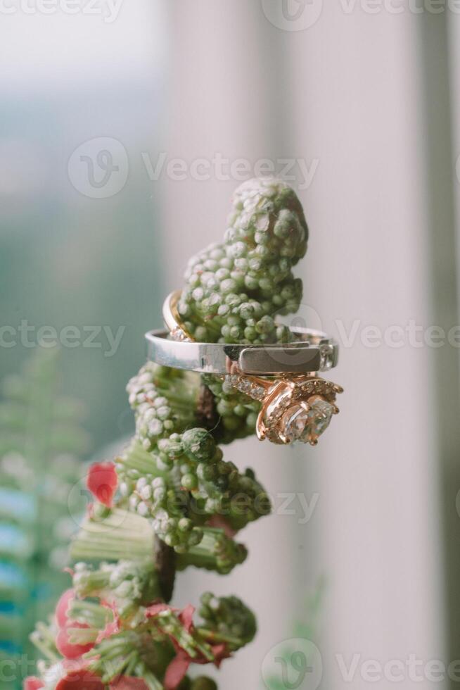 Wedding ring on an artificial plant stem, blending love with nature's charm photo