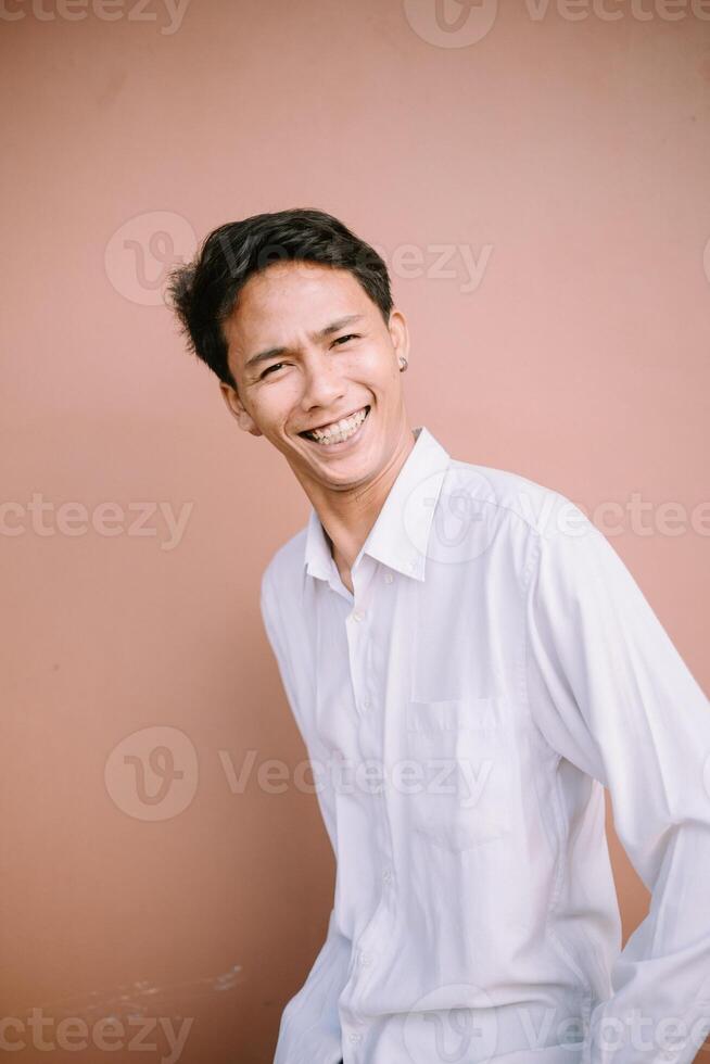 A man with a wide smile, looking forward, radiating joy and friendliness. photo