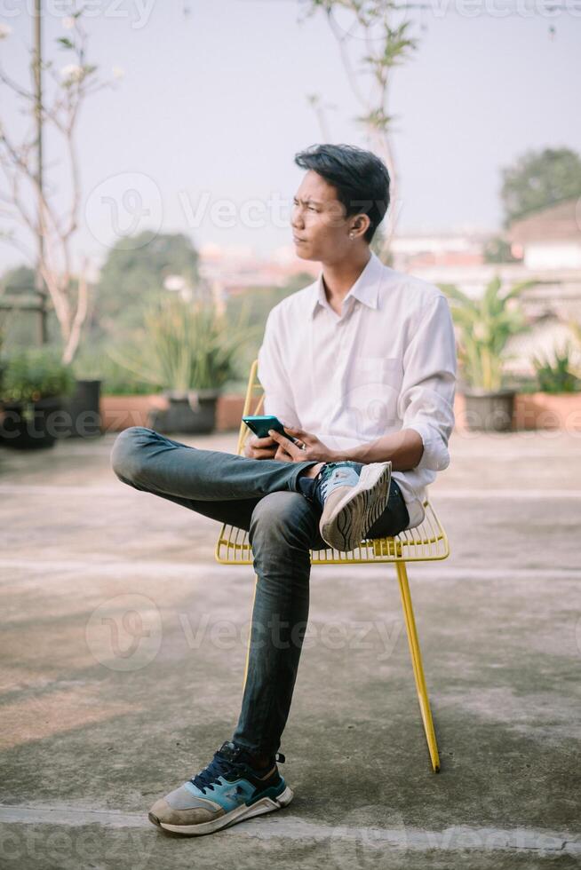 A person with a baffled expression, looking at something confusing on their phone photo