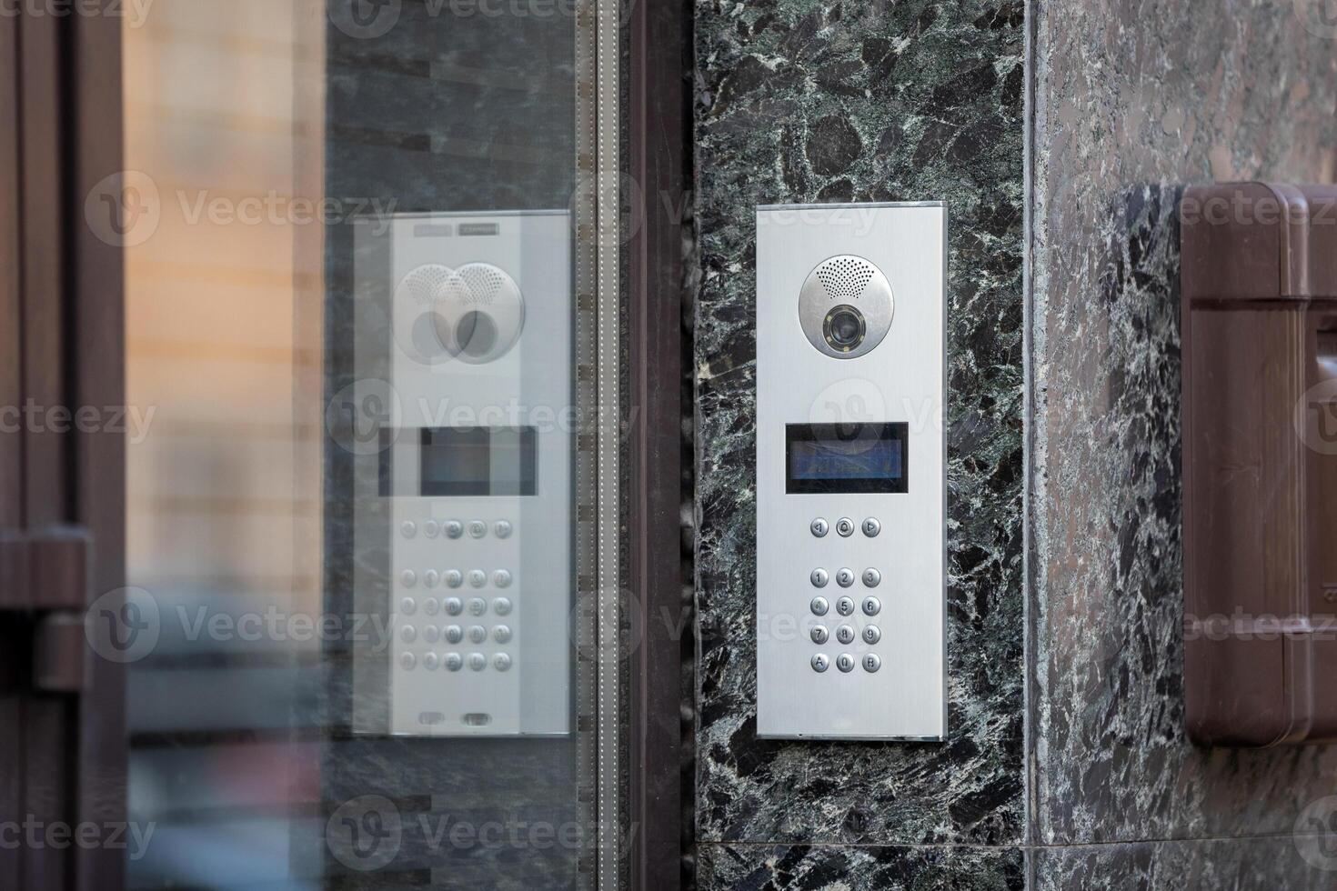 Intercom with camera on the wall of the house photo