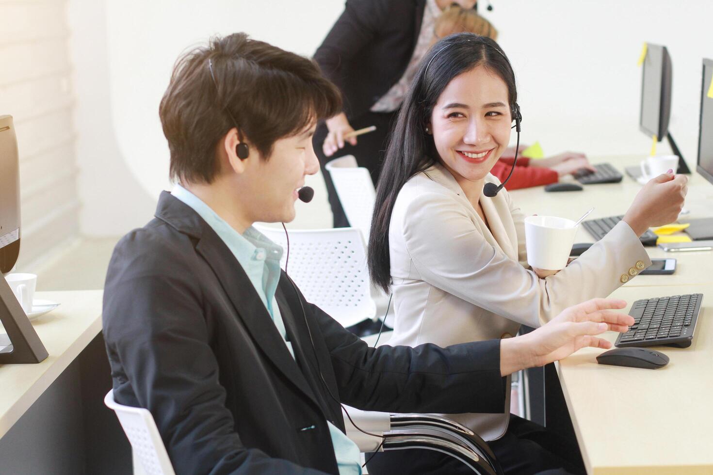 Business Call Center and technical Support staff or receptionist phone operator Discussing and working for teamwork with computer. Asian customer support team. photo