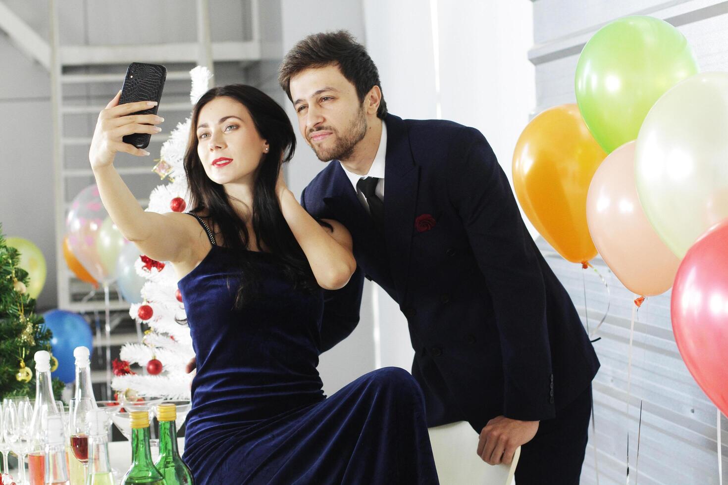 Sweet couple Love smile and spending Romantic for Take a picture with a mobile phone in christmas time and celebrating new year eve, valentine day with colorful balloons in pantry area. photo