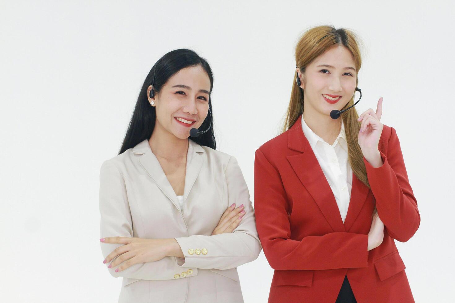 Smiling couple businesswoman Call Center meeting with Colleague for Technical Support staff or receptionist phone operator teamwork. Asian customer support team. photo