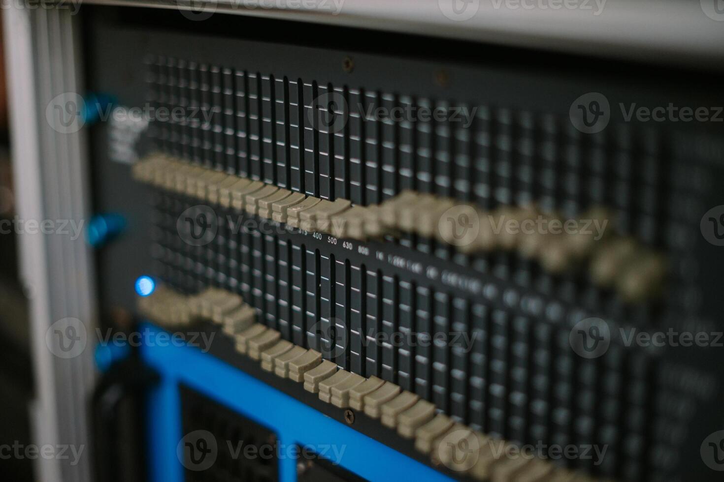 An audio mixer with its knobs and sliders meticulously adjusted, embodying precision and control in the art of sound engineering and music production photo