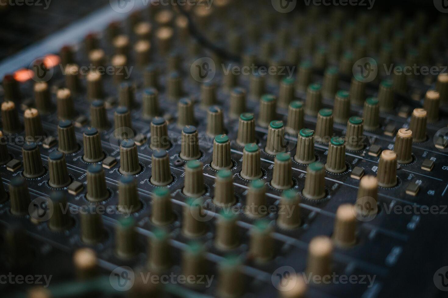 An audio mixer with its knobs and sliders meticulously adjusted, embodying precision and control in the art of sound engineering and music production photo