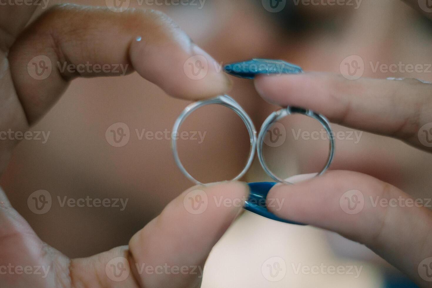 Newlyweds holding their wedding rings together, symbolizing their union and the beginning of a lifelong journey of love and commitment photo