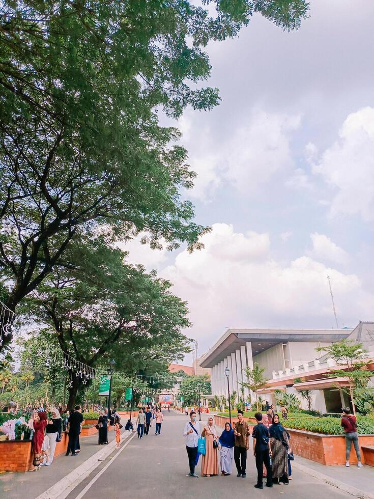 Jakarta, April 30 2024. The iconic entrance of Taman Mini Indonesia Indah TMII, adorned with intricate architectural details, as people stroll by, embracing the nation's rich cultural heritage photo