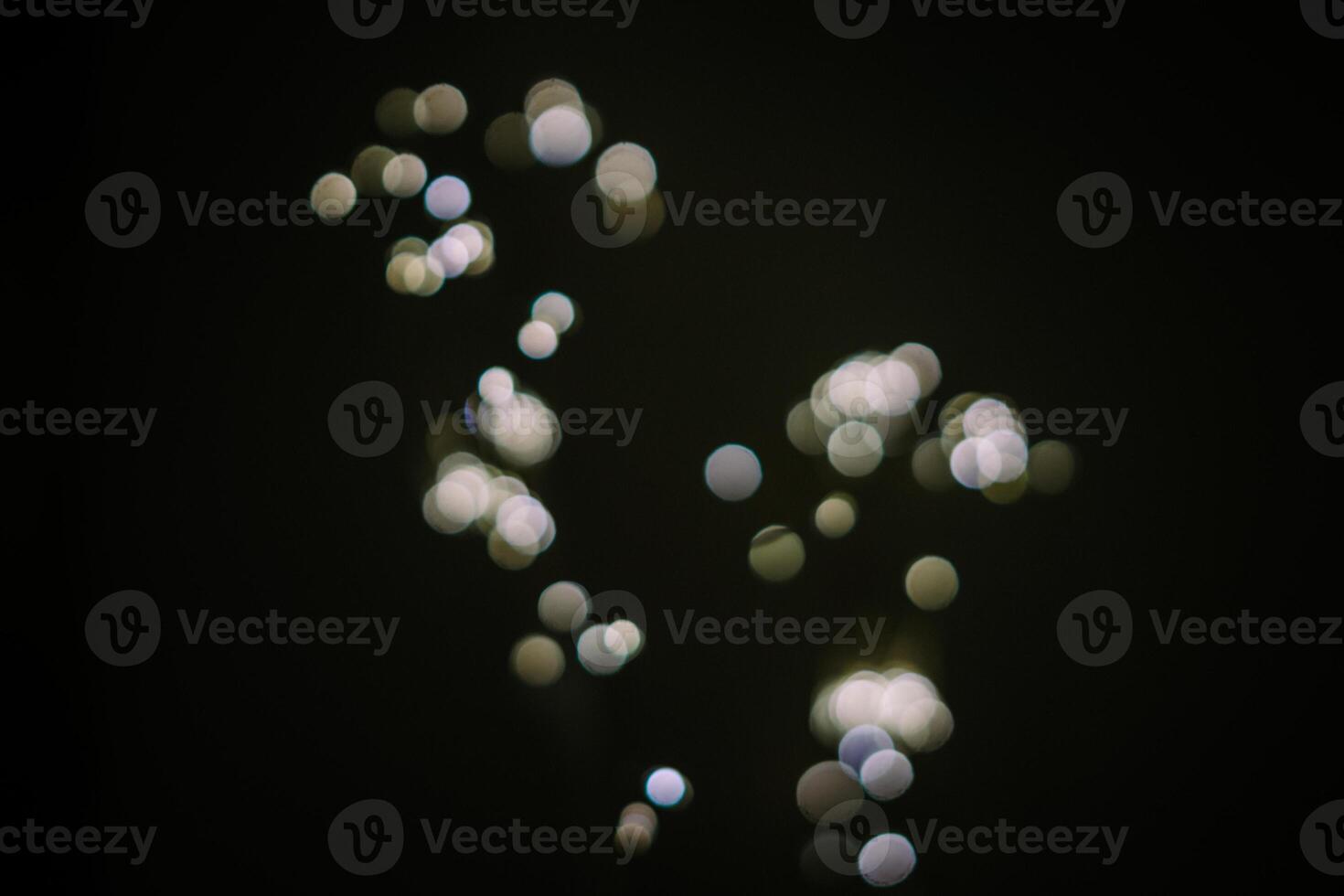Softly blurred white light emanates, casting an ethereal glow against a dark backdrop, evoking a sense of mystery and tranquility photo
