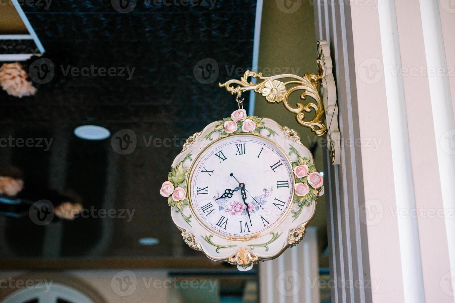 A wall clock hung on a wall, its hands ticking away the moments, symbolizing the passage of time in any setting photo