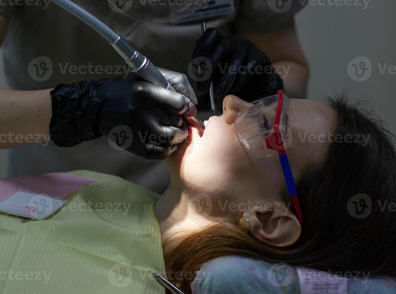 A woman at a dentist's appointment to replace arches with braces photo