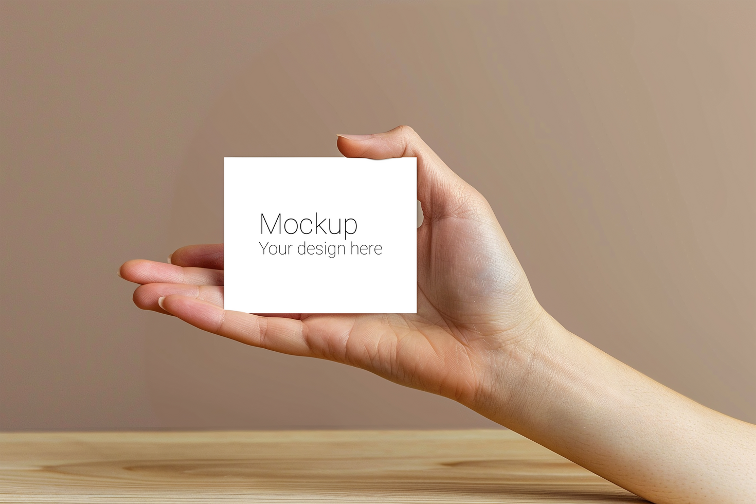 Mockup of greeting card in hand on beige background psd