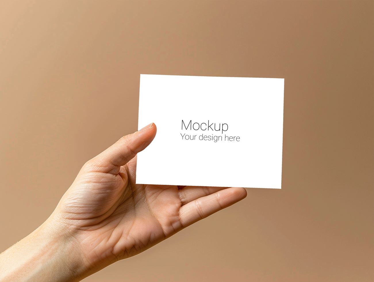 Mockup of greeting card in hand on beige background psd