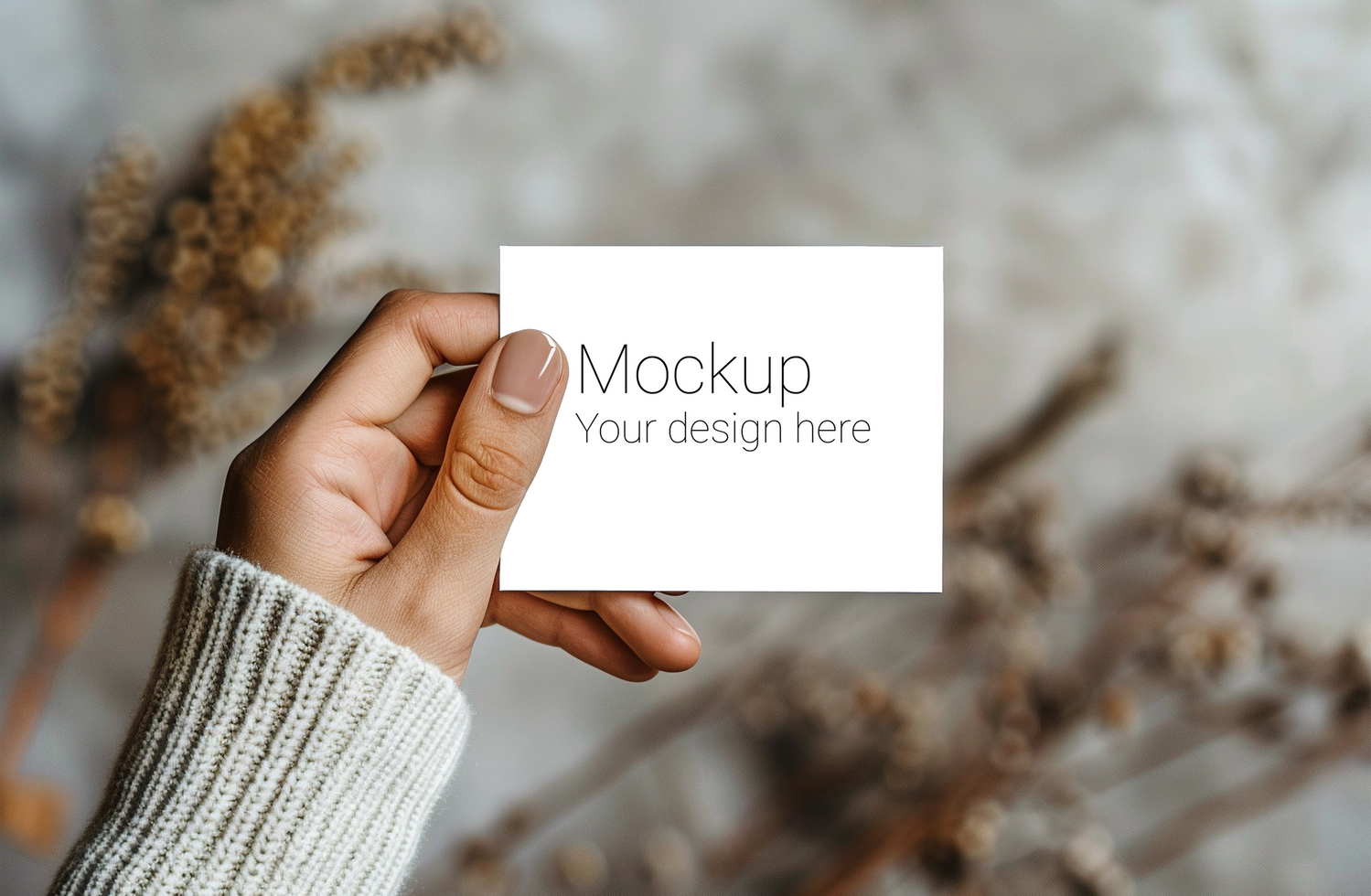 Mockup of greeting card in hand on background of plants psd