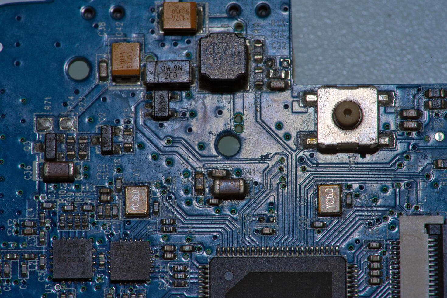 a close up of a blue electronic circuit board photo