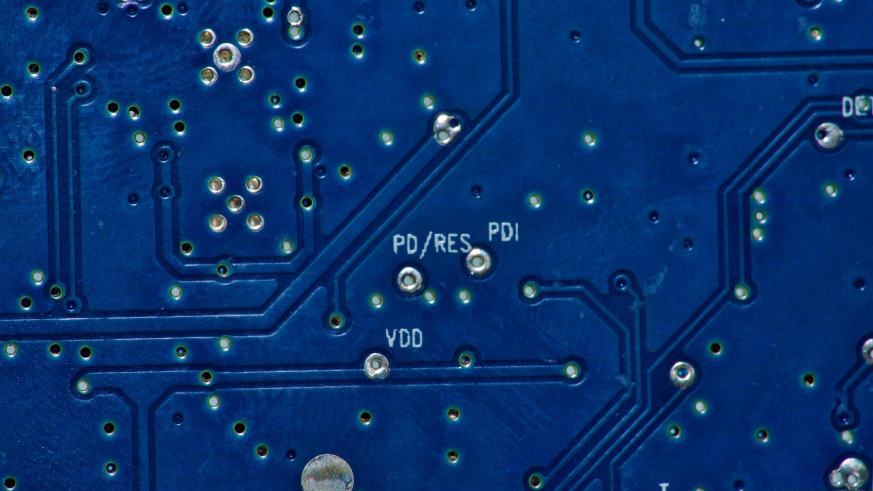 a close up of a circuit board with gold and silver circles photo