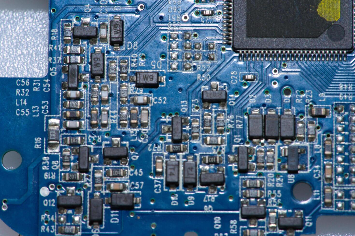 a close up of a blue electronic circuit board photo