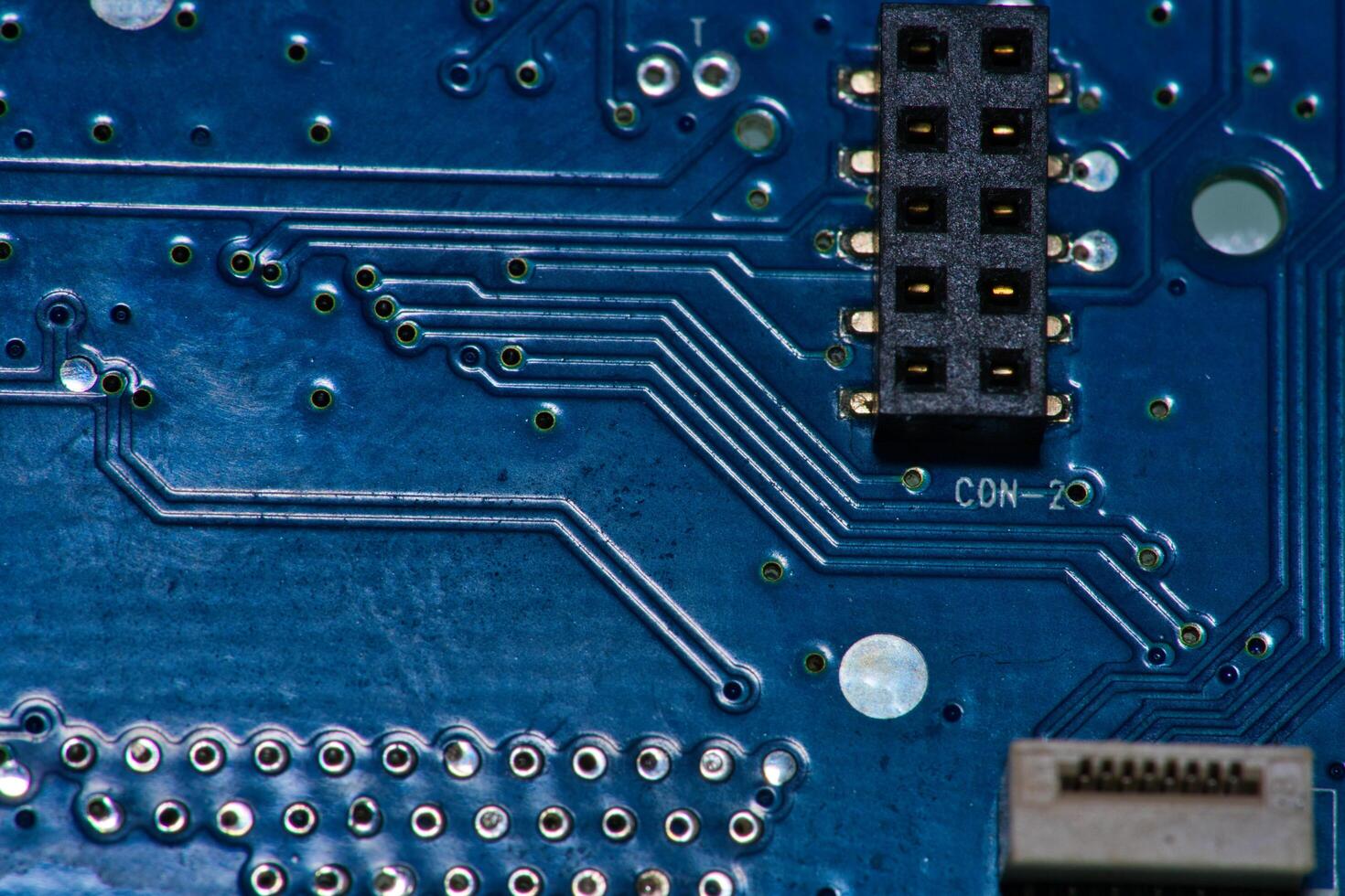 a close up of a circuit board with gold and silver circles photo