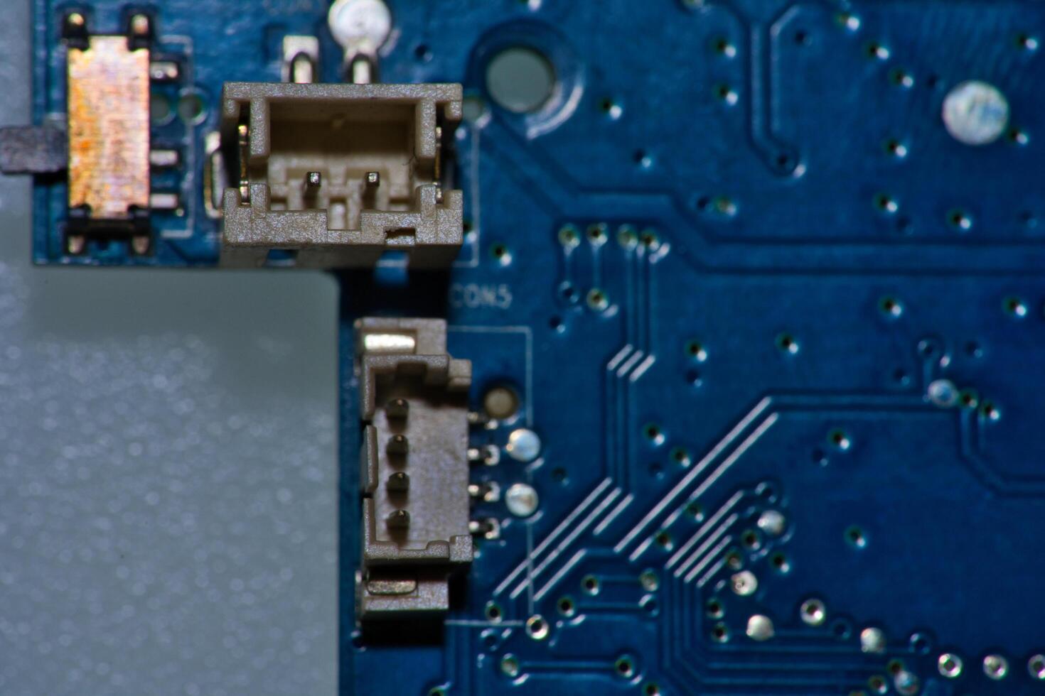 a close up of a circuit board with gold and silver circles photo