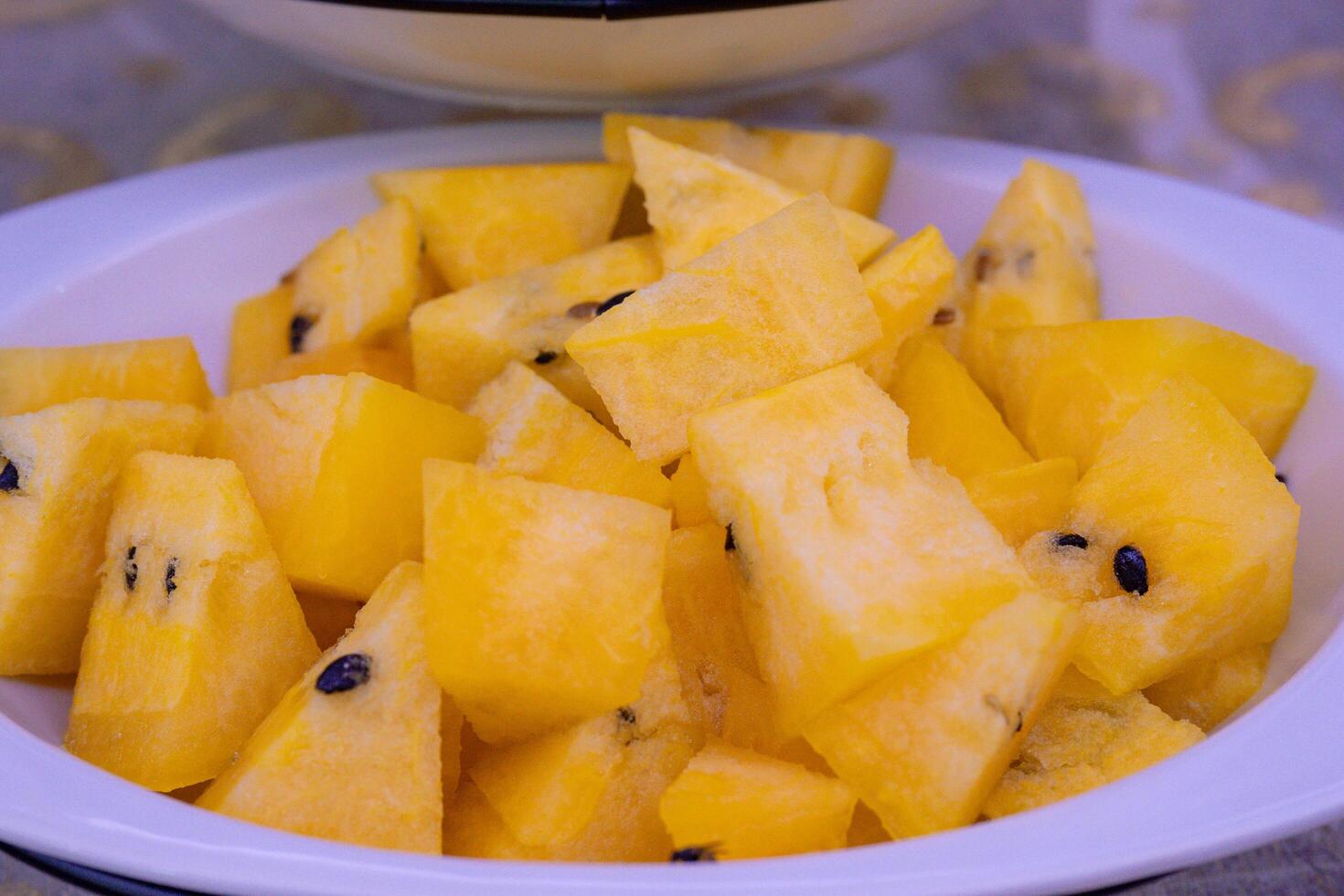 a bowl of sliced yellow watermelon photo