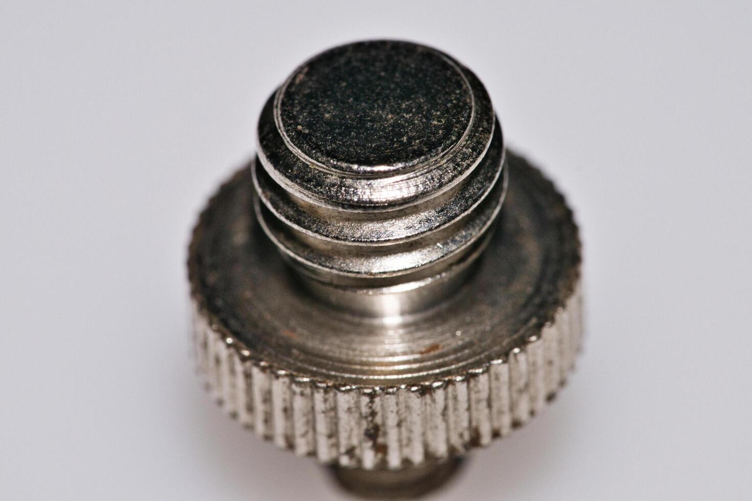 a close up of a metal screw with a small knob photo