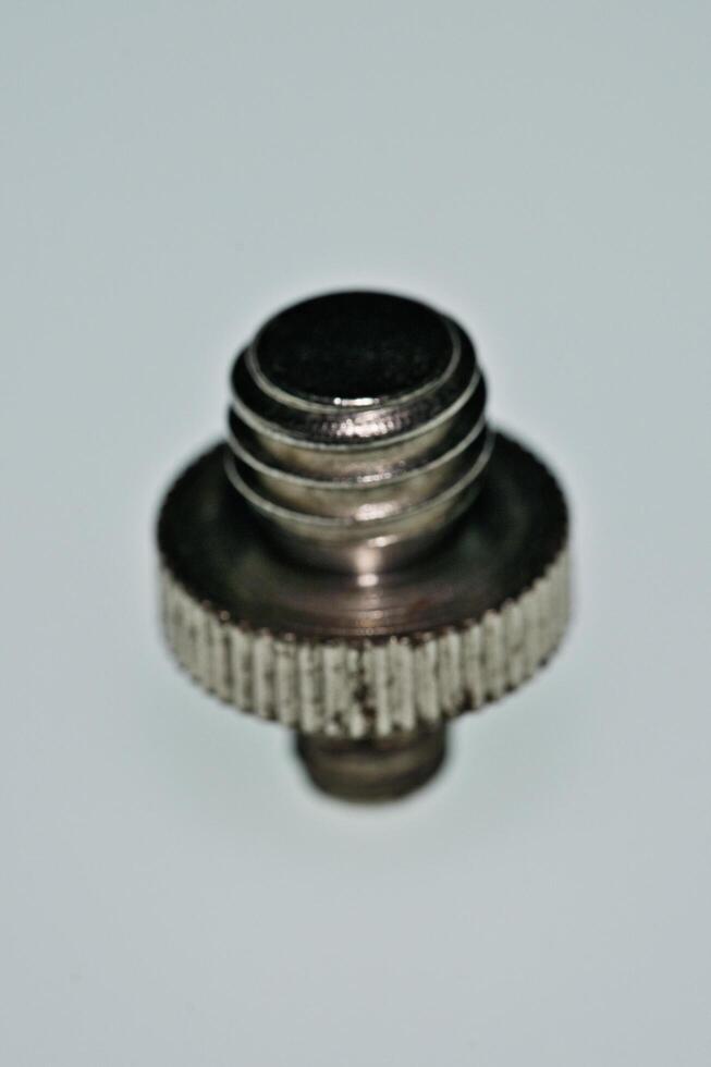 a close up of a metal screw with a small knob photo