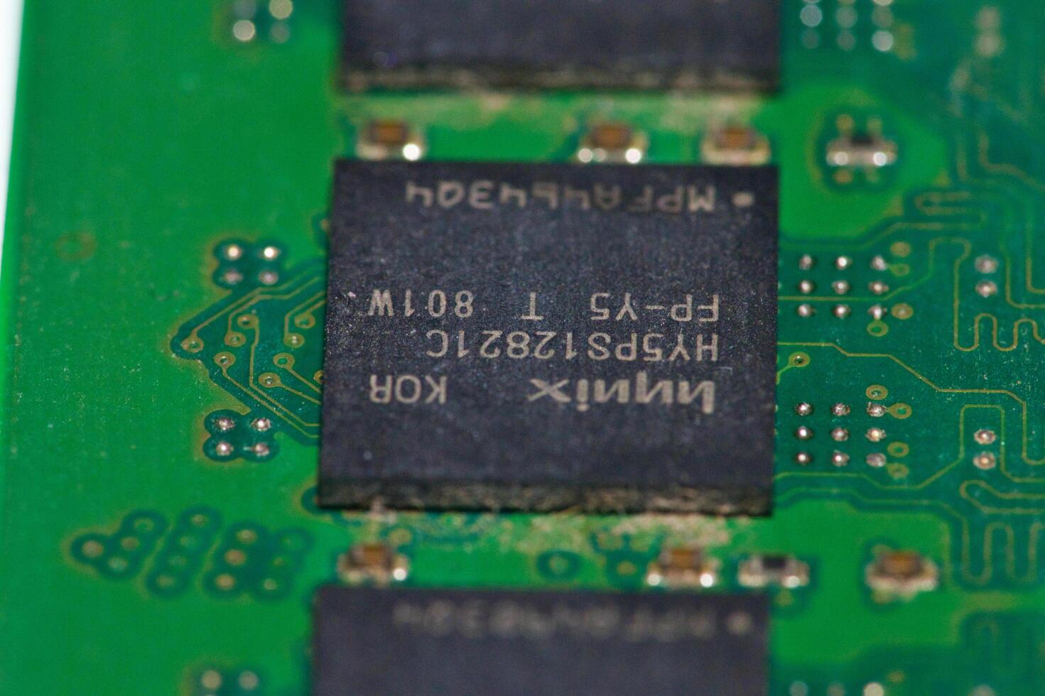 a close up of a green electronic circuit board photo