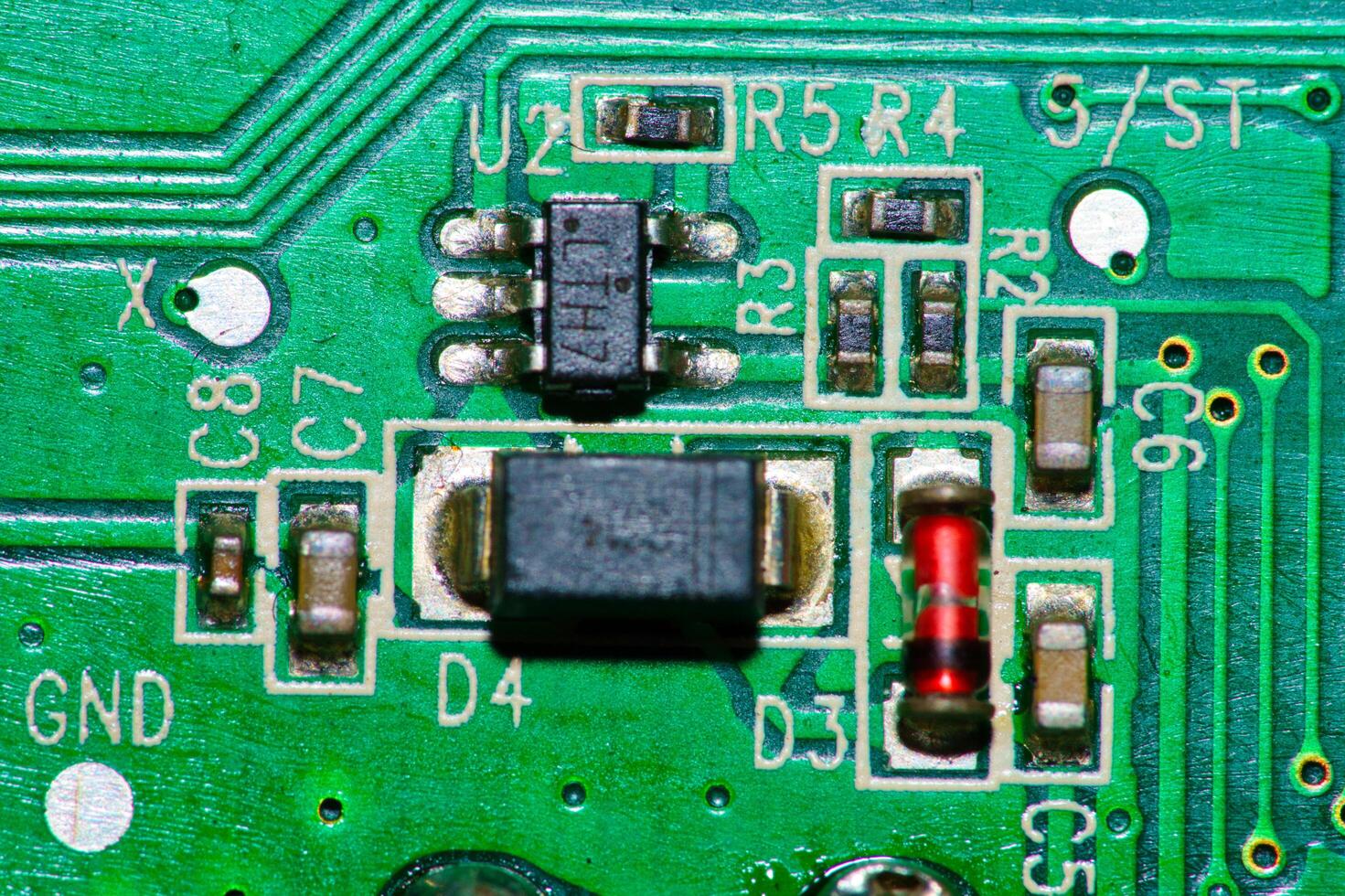 a close up of a green electronic circuit board photo