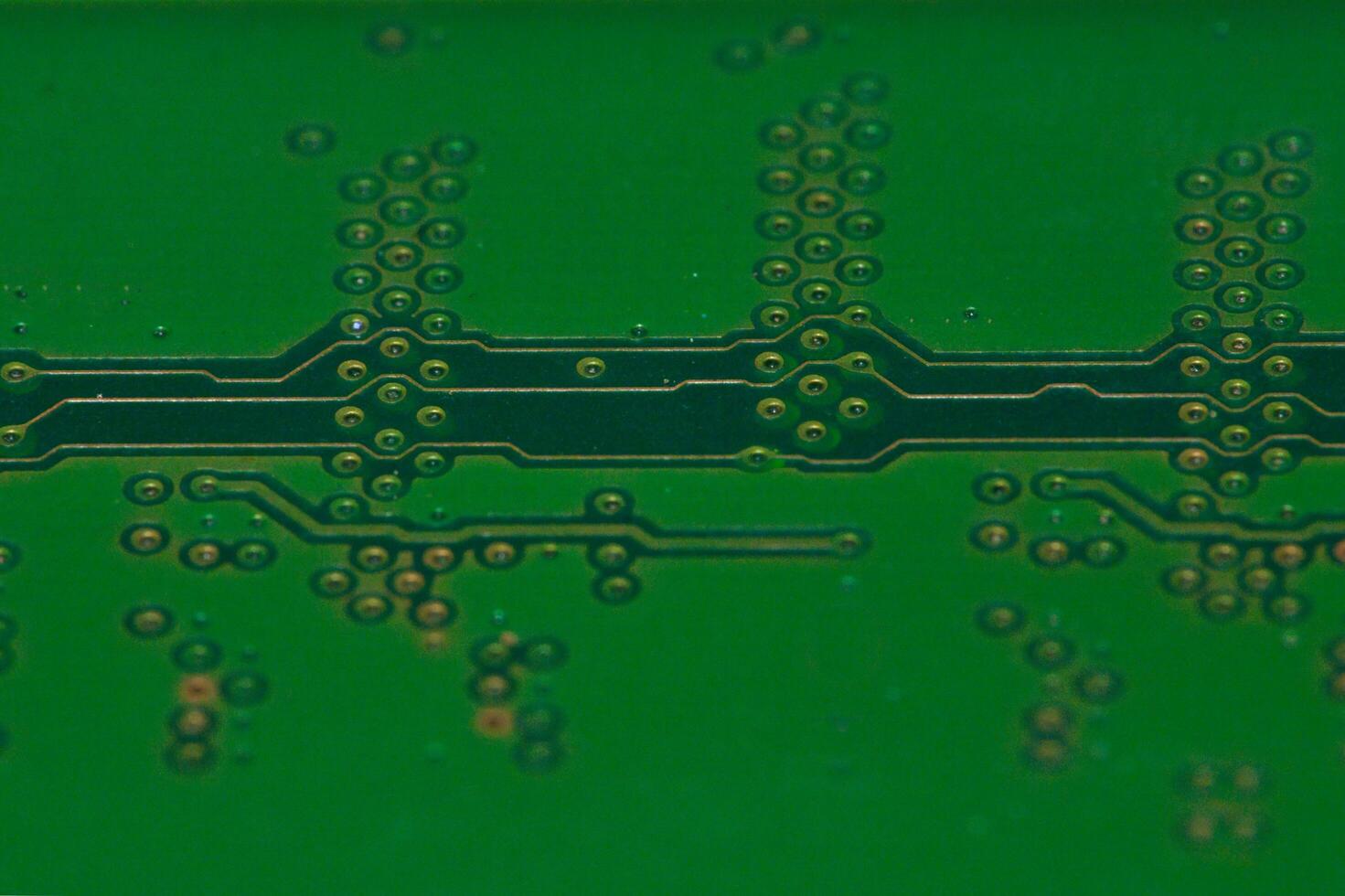 a close up of a green electronic circuit board photo