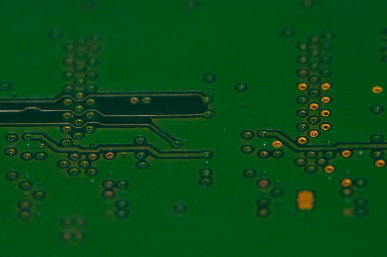 a close up of a green electronic circuit board photo