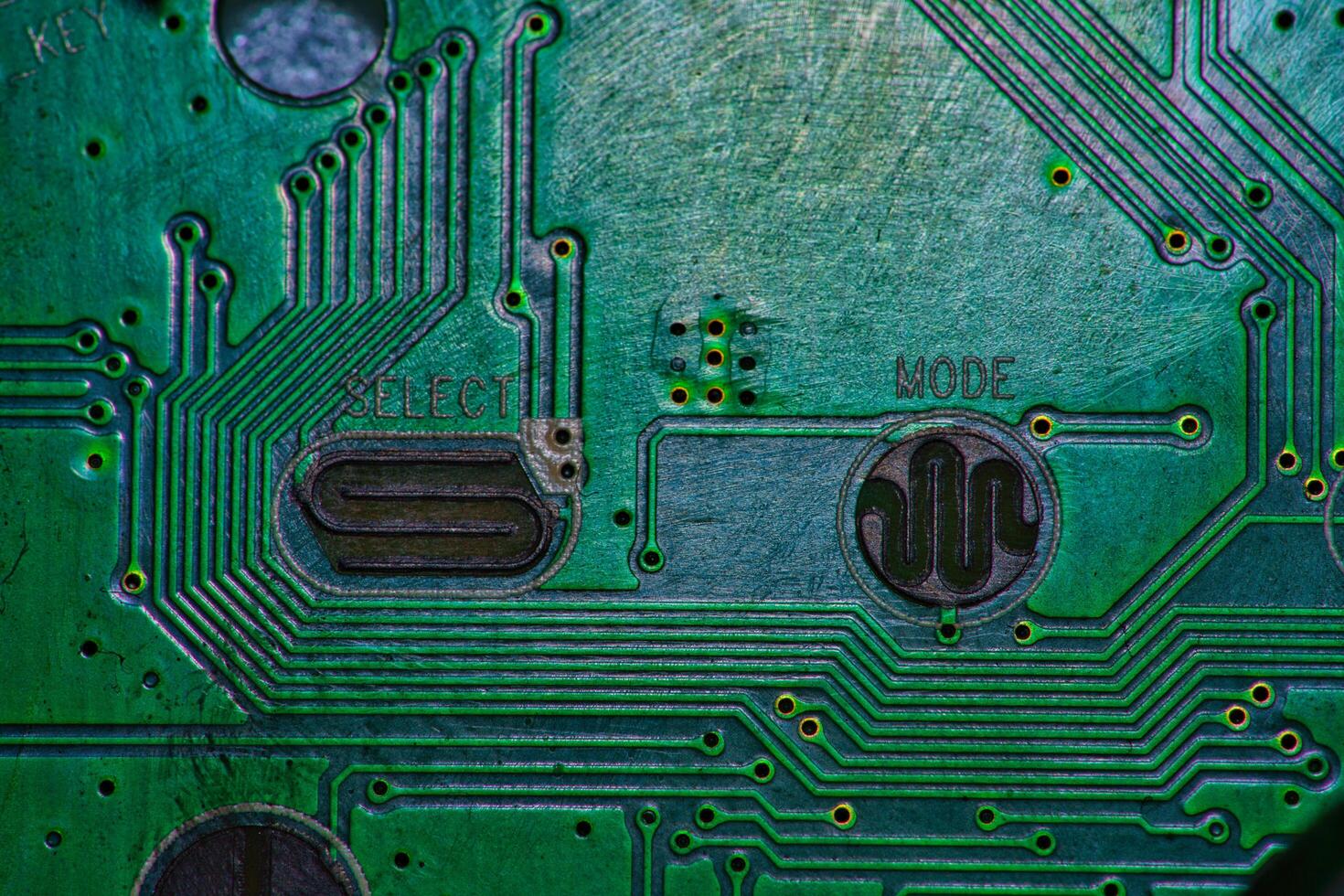a close up of a green electronic circuit board photo