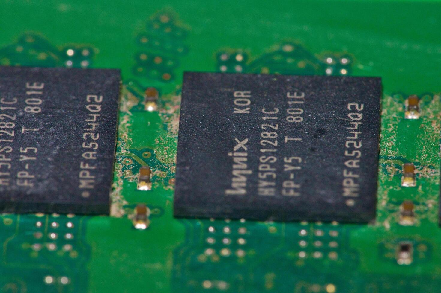 a close up of a green electronic circuit board photo