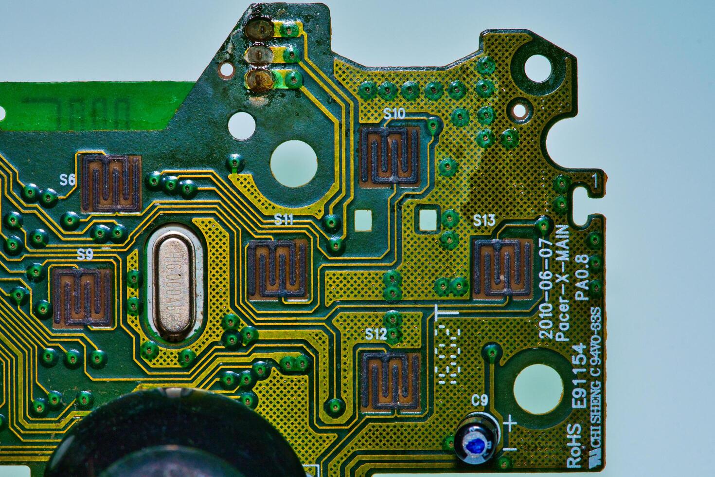 a close up of a green electronic circuit board photo