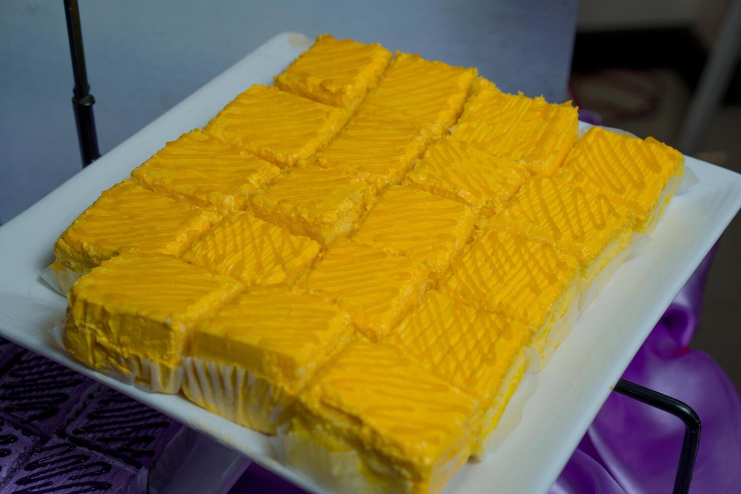 a square of yellow cake on a plate photo