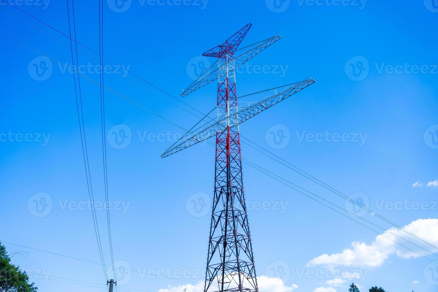 A new iron electric tower is being built. Photo of a spring day. Czech
