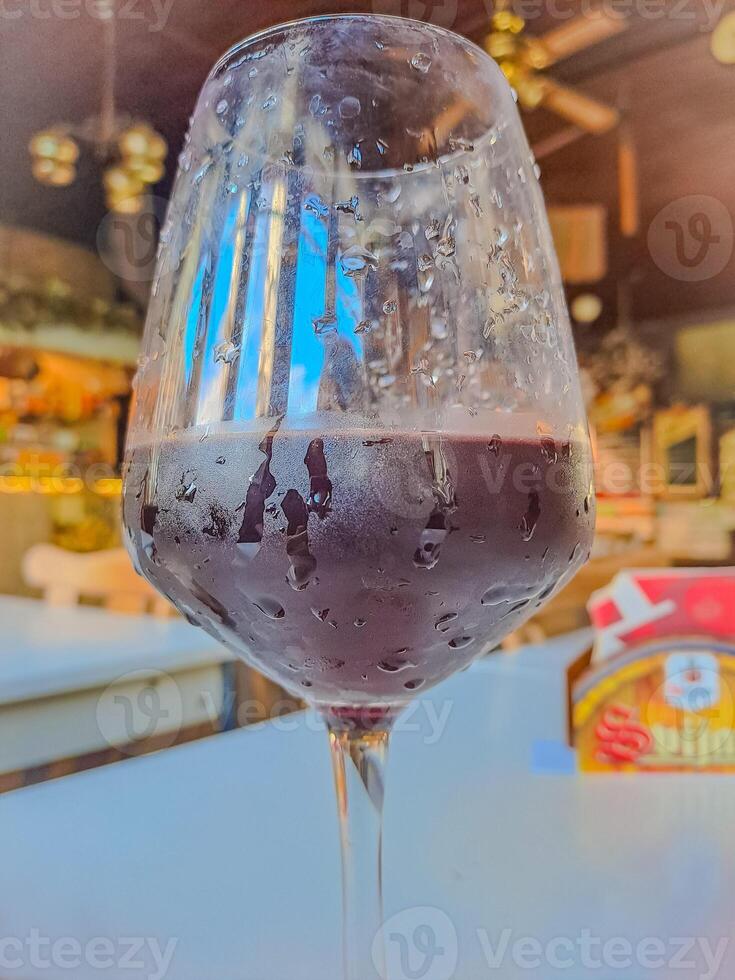 Red wine pouring in wineglass from bottle. Wine list design menu with copyspace photo