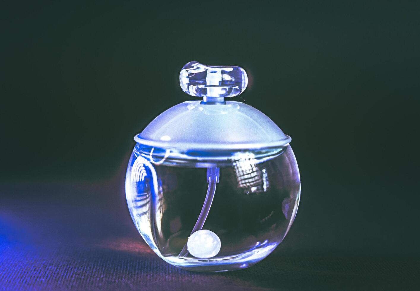 Perfumery. A bottle of perfume with a pearl inside photo
