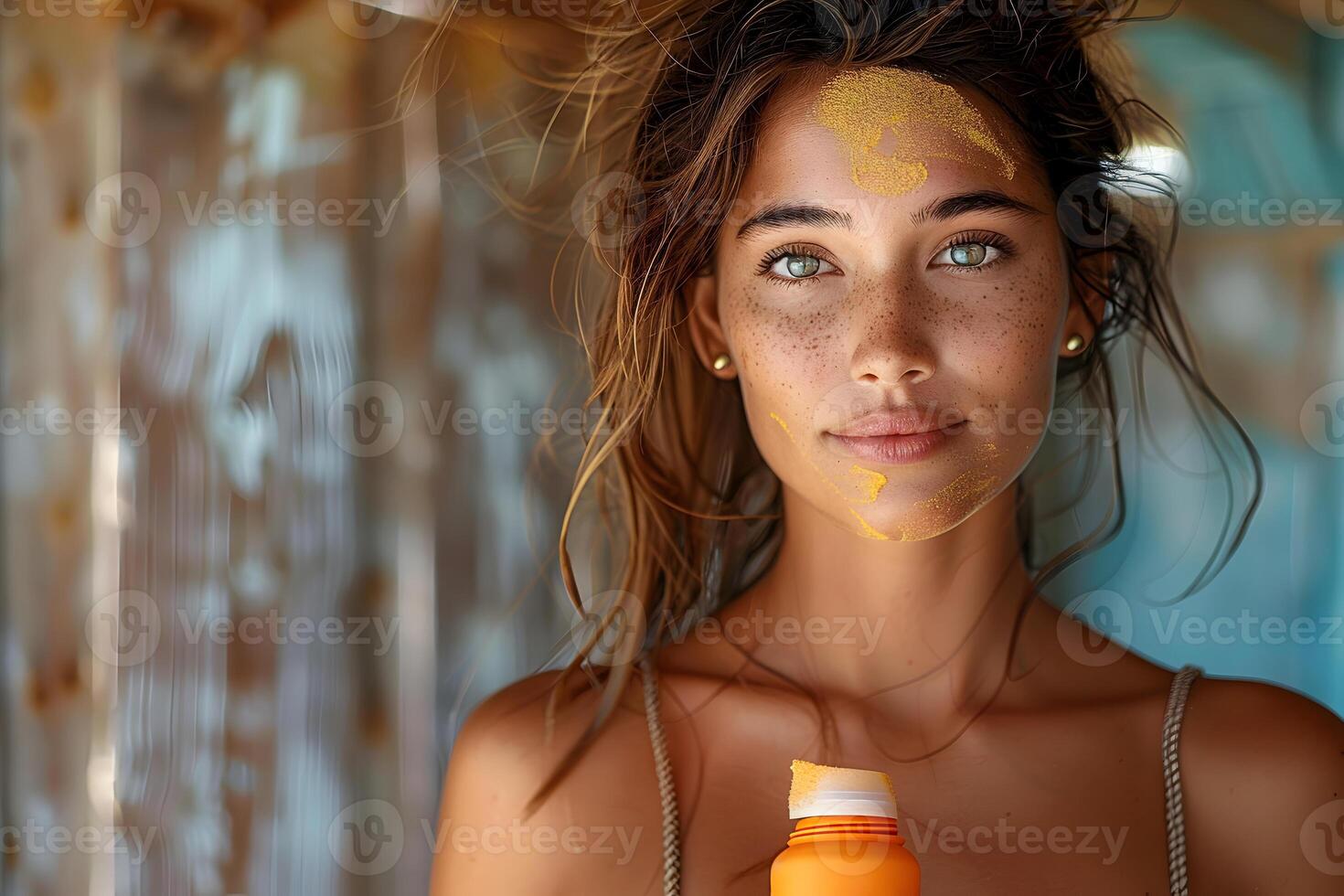 Close up portrait of young woman with sunscreen on her face and sun cream in the hand. Sun safety for summer, sun protection factor, skincare, cosmetology and beauty concept with copy space. photo