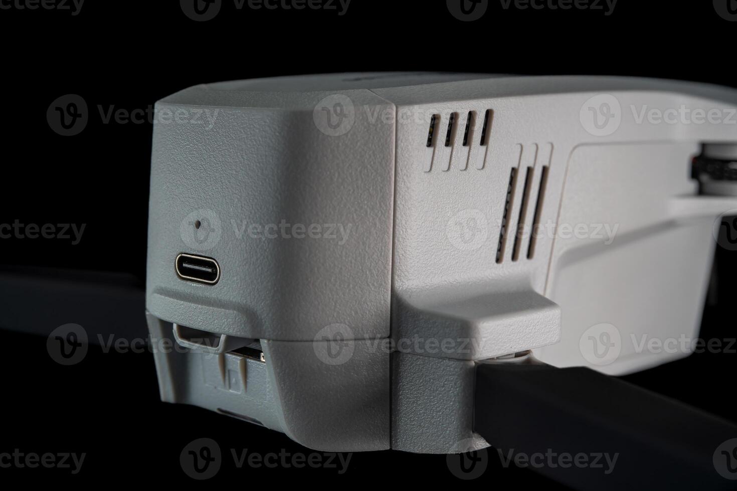 Close-Up of a White Drone With USB Port on Black Background During Daytime photo
