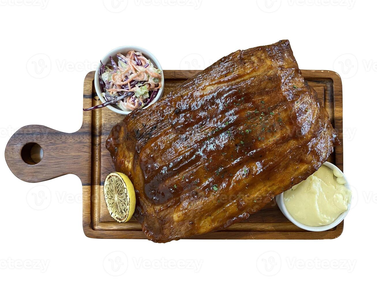 pork rips steak on wooden tray with mashed potatoes and salad isolated white background. photo